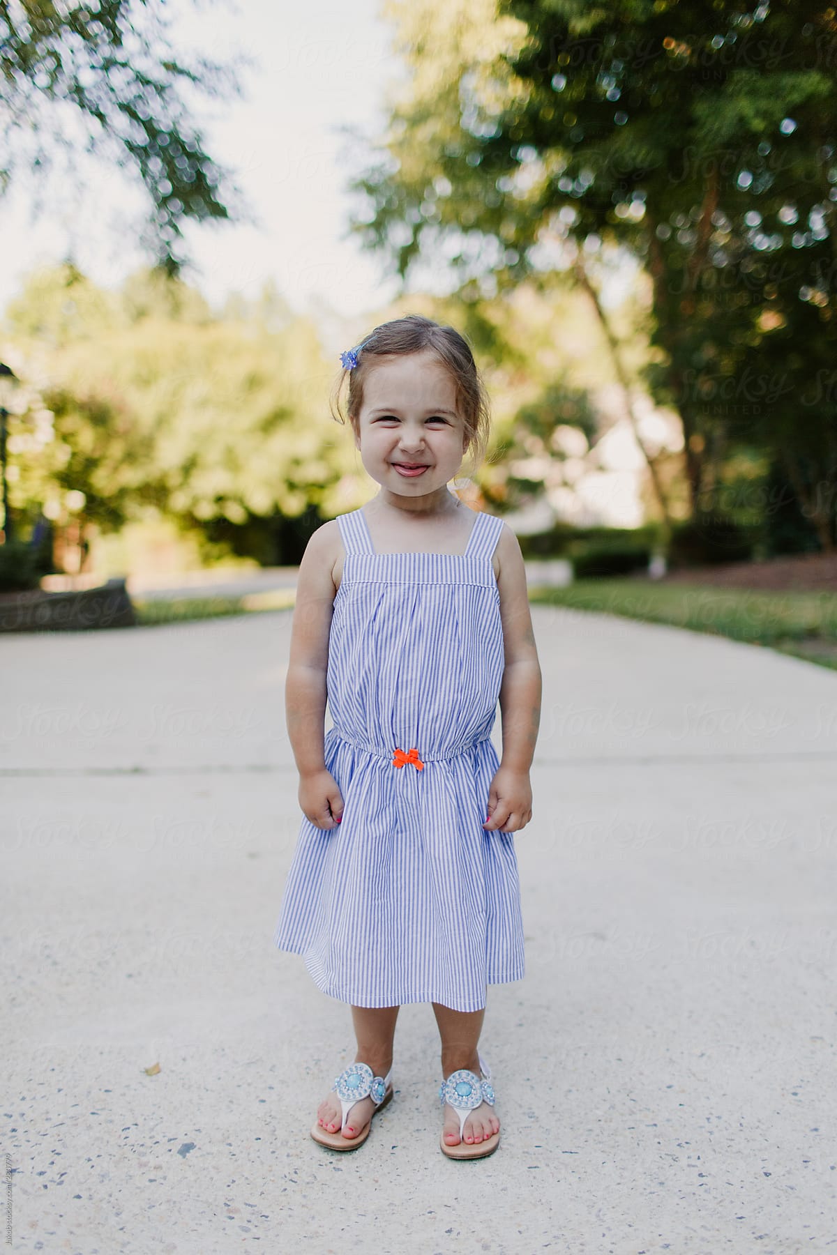 Trendy and happy toddler in a cute dress