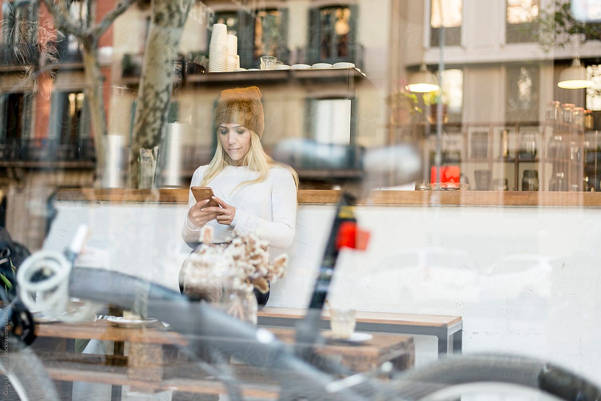 Woman texting at café