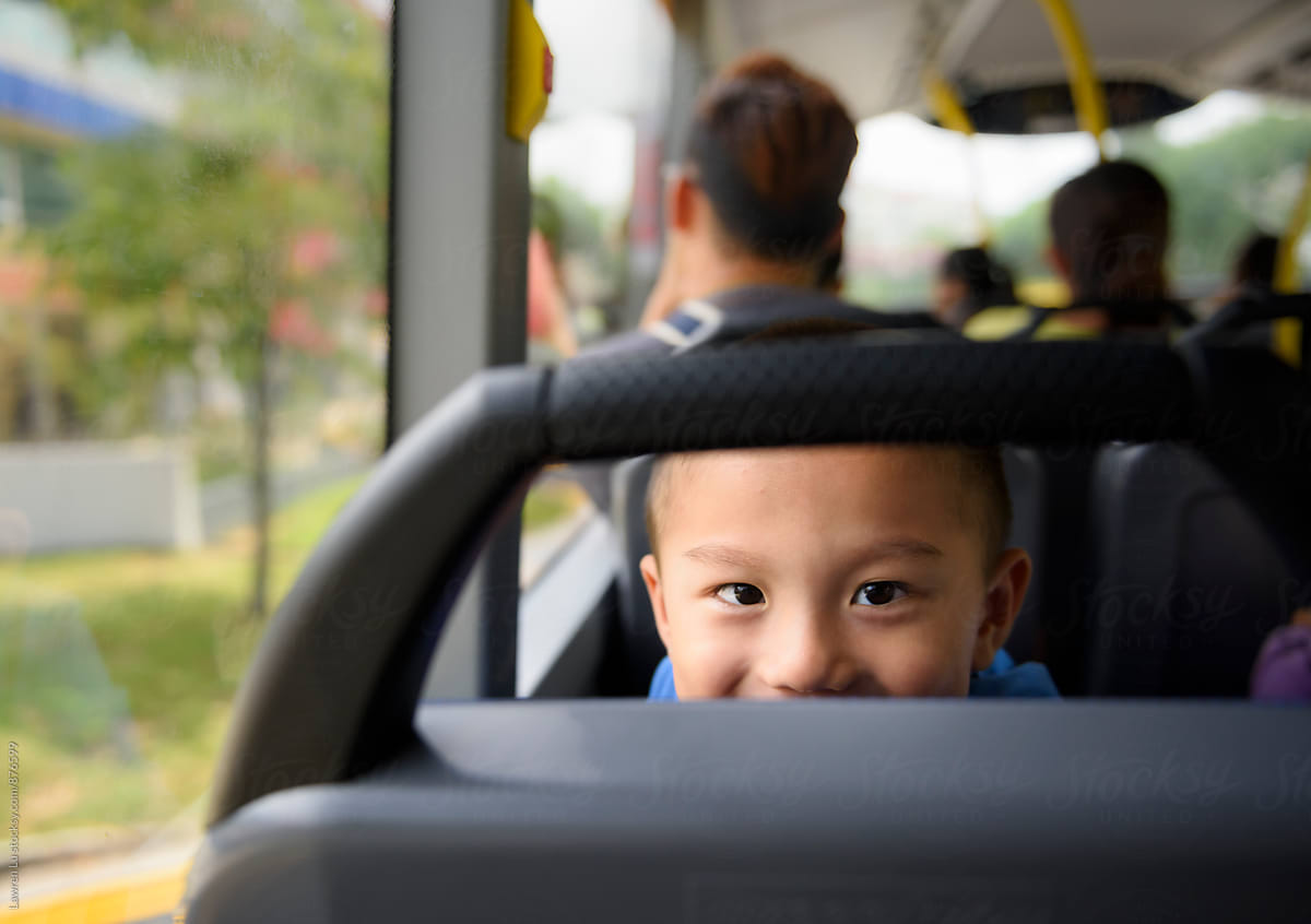 Child looking at camera on bus