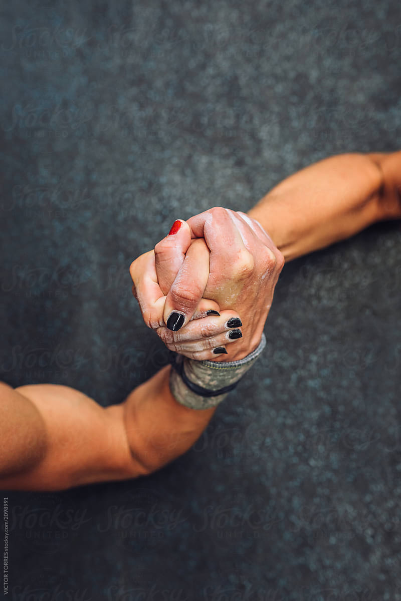 Hands clasped during arm wrestling challenge