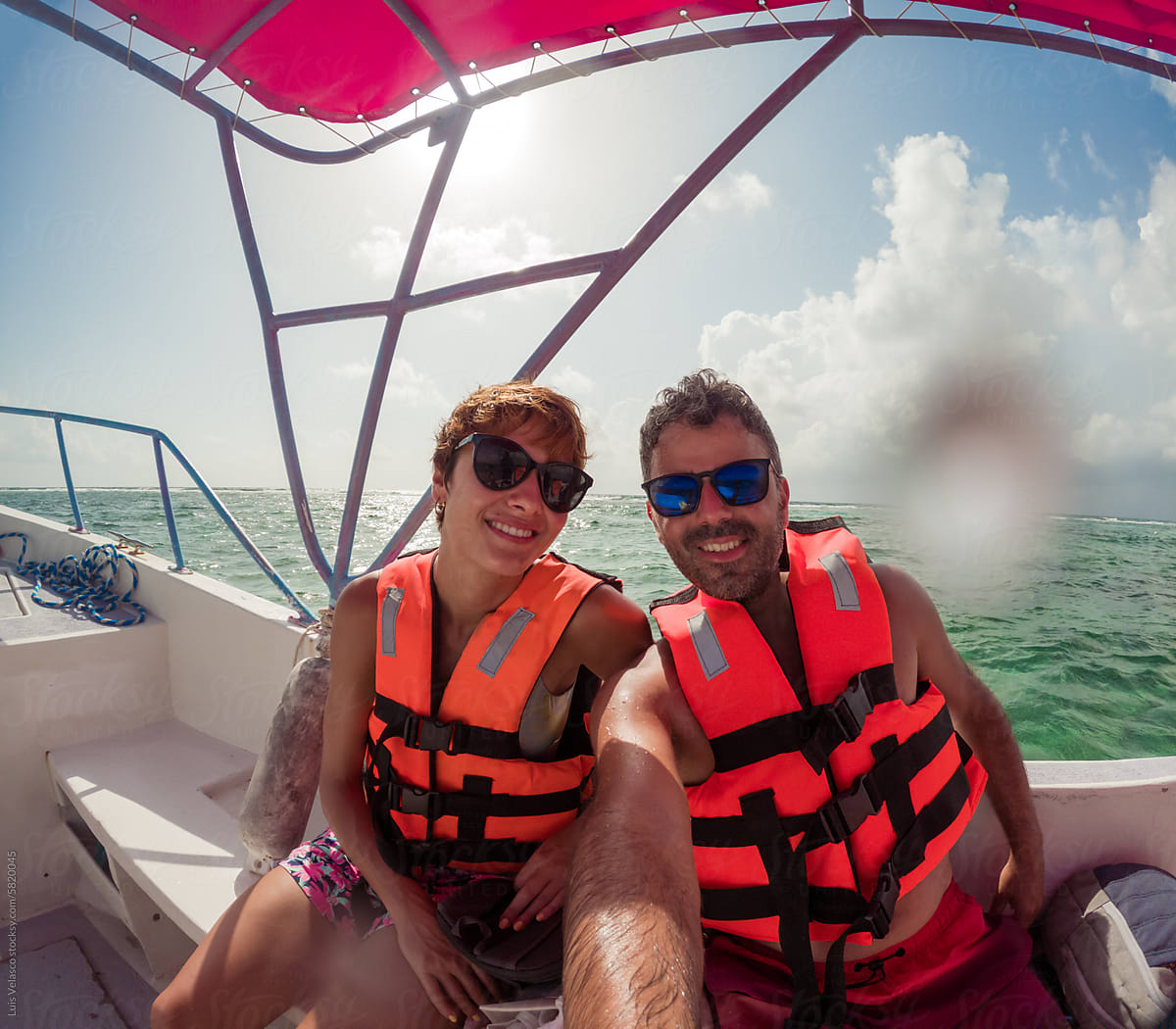 Couple With Sunglasses On A Boat During Holidays.