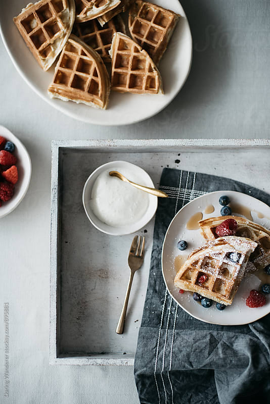 Waffles with berries on marble countertop for breakfast