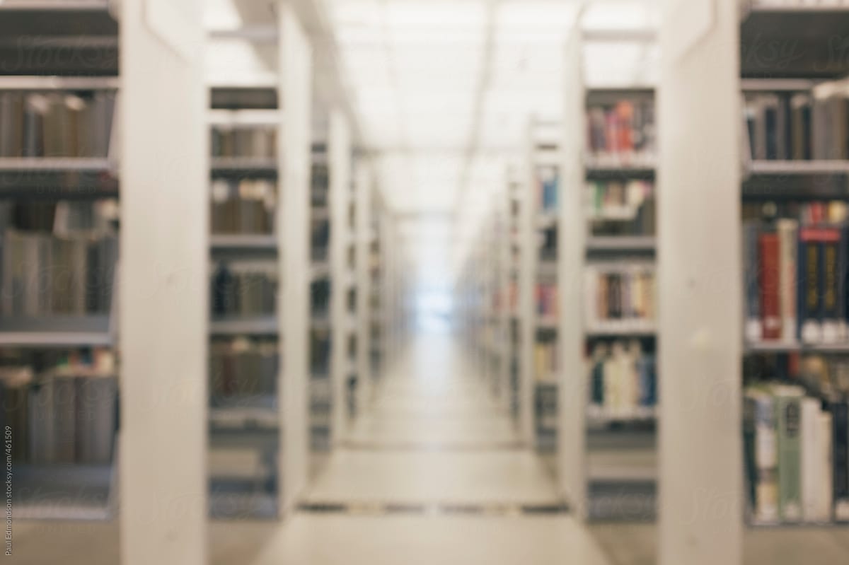 Rows of bookshelves in ultra-modern public library, blurred focus