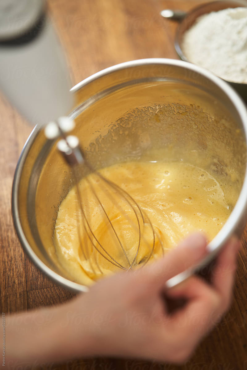 Adding ingredients to the dough in a kitchen
