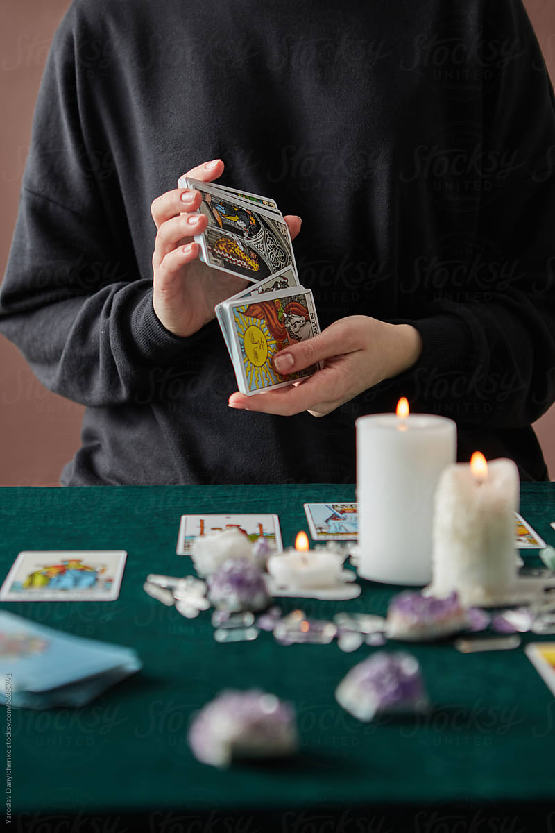 Fortune teller shuffling tarot cards.
