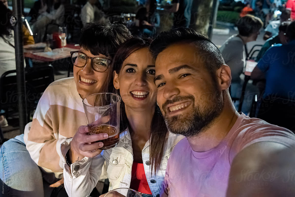 selfie of friends having fun at a bar terrace