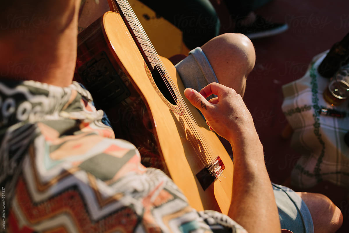 Man\'s hands playing a spanish guitar