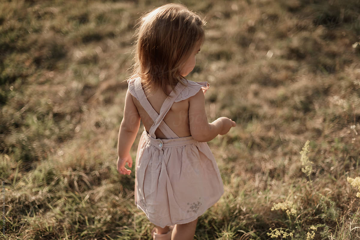 Toddler  girl walks across the field