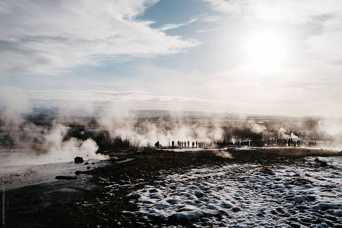 People look at the gesyers in Iceland