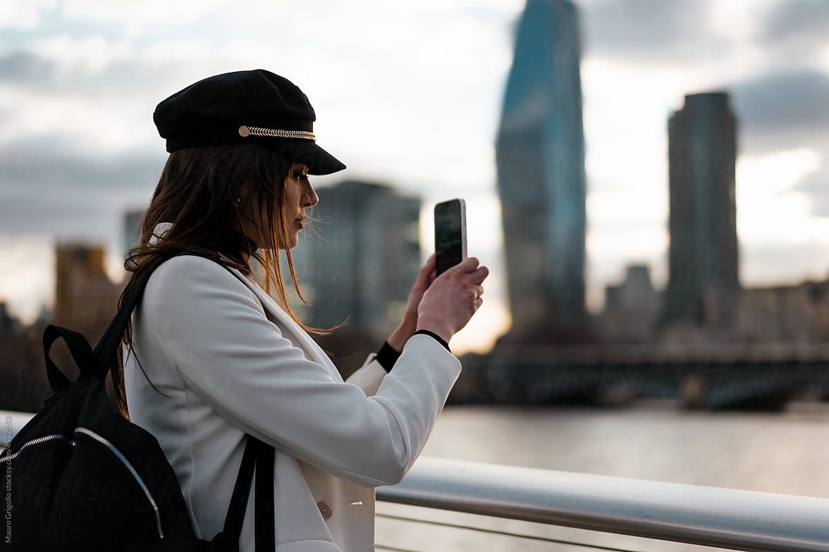 Tourist woman taking photos with her mobile phone