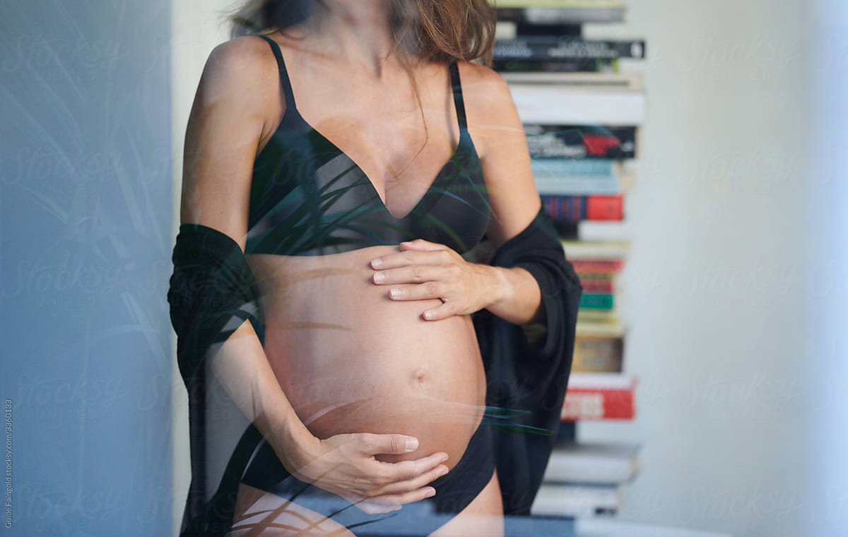 Pregnant woman behind glass wall