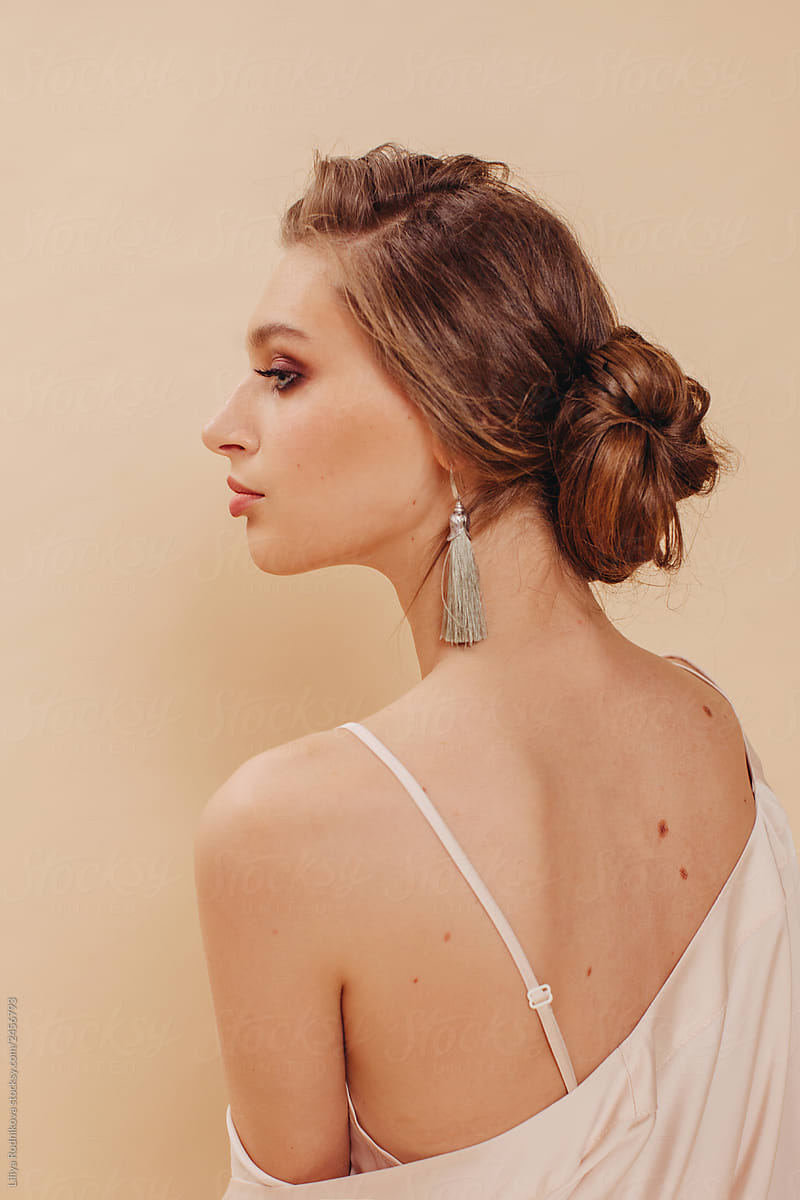 Back view portrait of elegant young blond woman