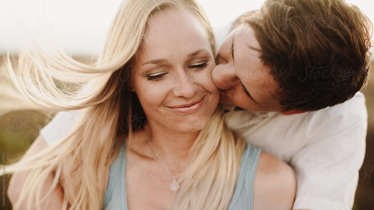 Man Kissing Woman On Cheek By Stocksy Contributor Sidney Scheinberg