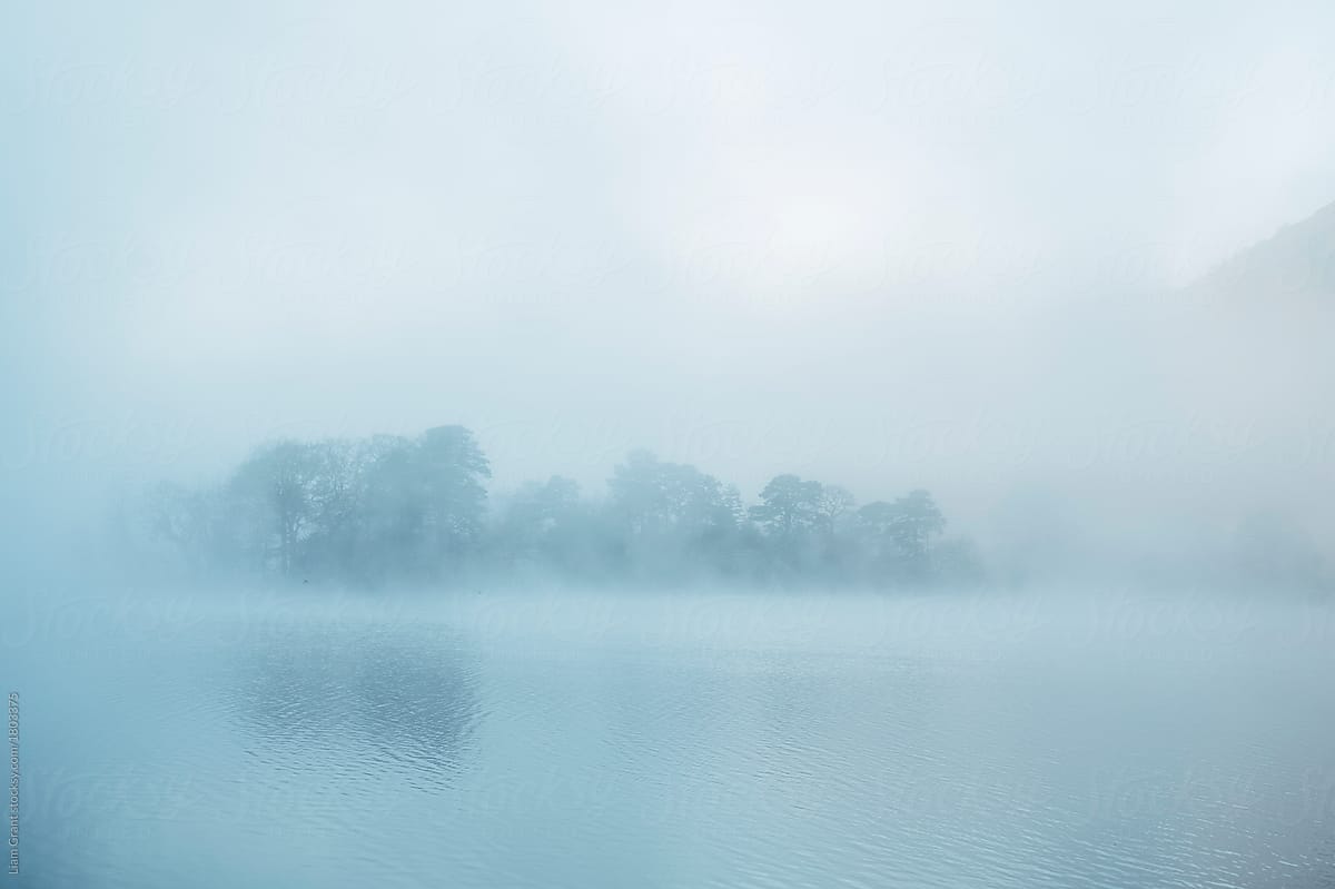 Fog on a lake at sunrise. Rydal Water, Cumbria, UK.