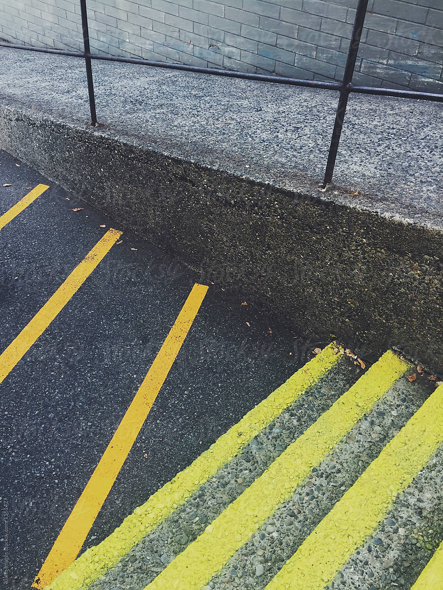 Freshly Painted Orange And Yellow Caution Lines On Steps And Street by Stocksy  Contributor Rialto Images - Stocksy
