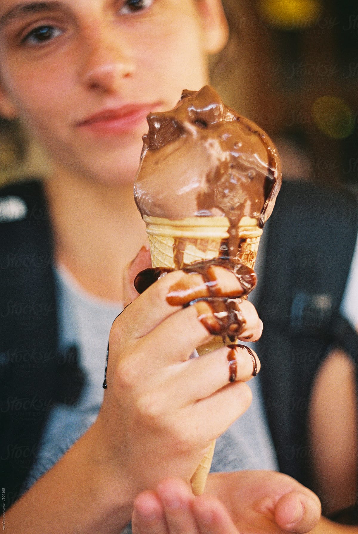 Girl with the chocolate ice cream during summer day
