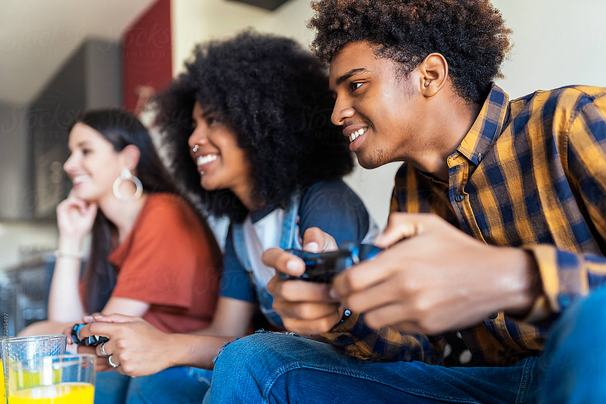 Young People Playing Video Games At Home Stock Photo, Picture and Royalty  Free Image. Image 113583143.