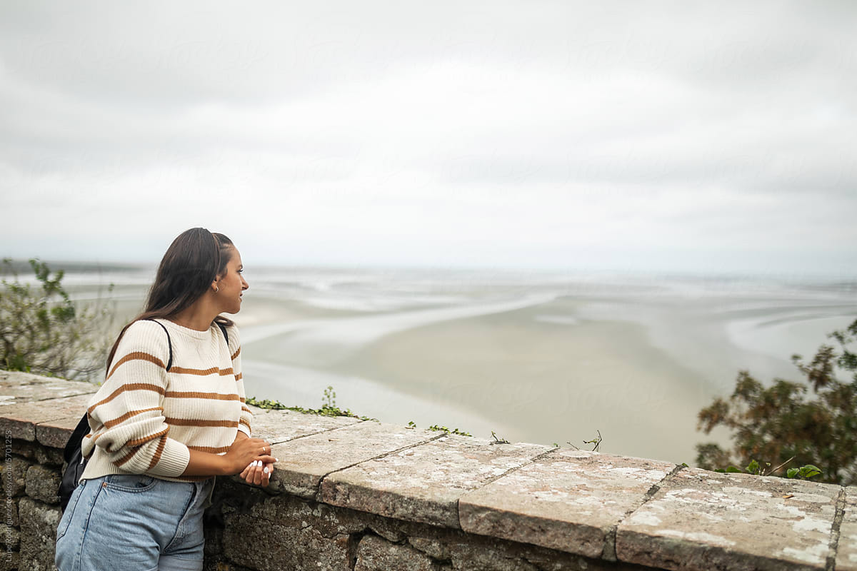 woman contemplating a seascape at Mont Saint Michel in France