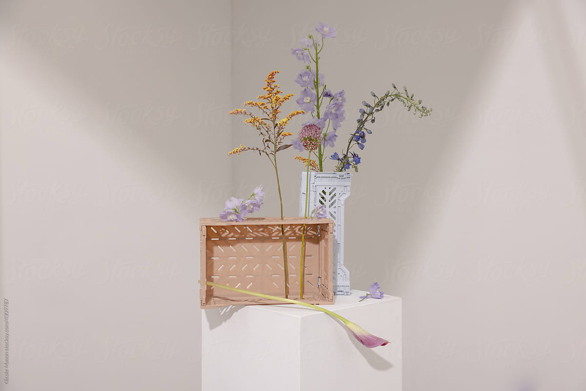 variety of flowers in pastel colored crates