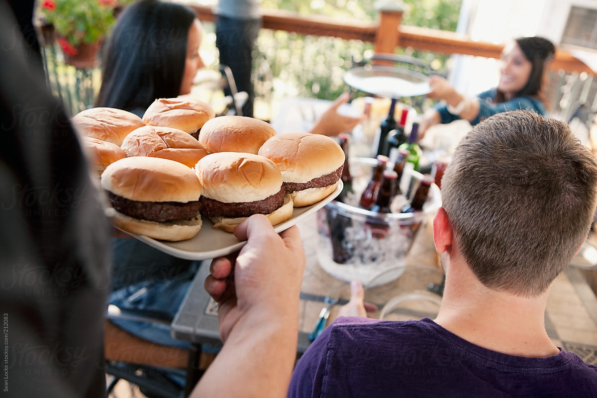 Party: Serving Up Platter Of Burgers To Friends