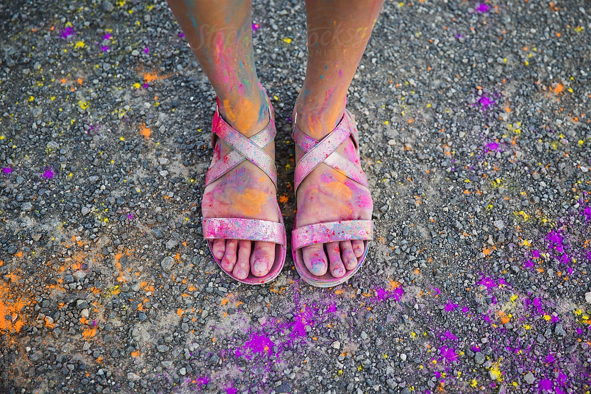 Female feet dirty with colored powder
