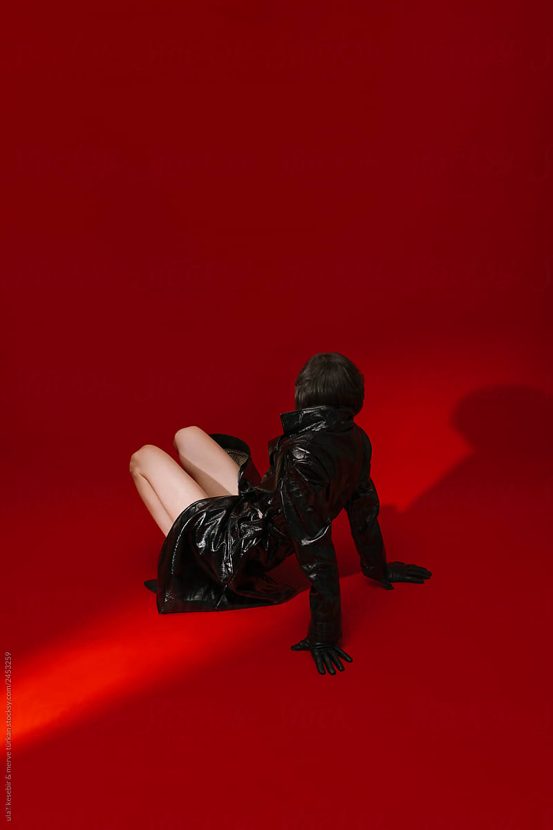 model with fake leather jacket on red background