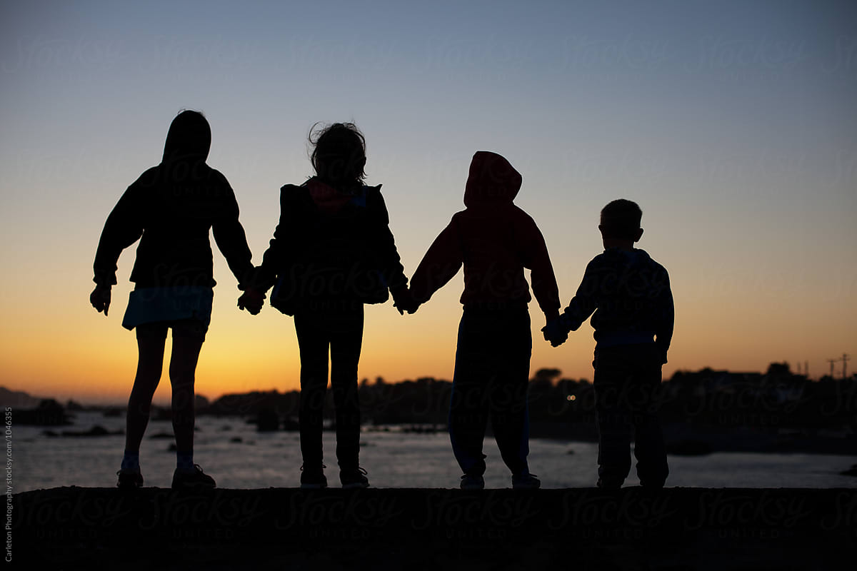 family holding hands silhouette