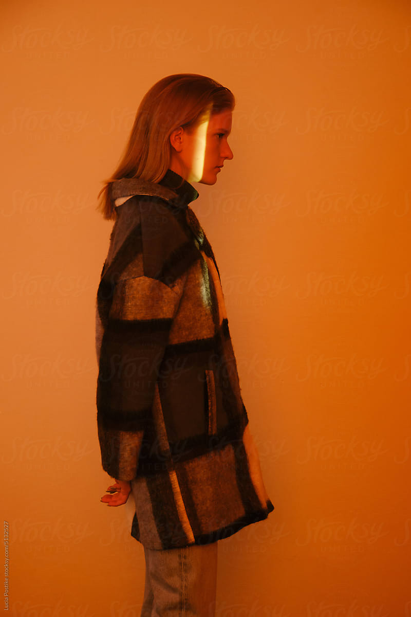 Calm profile of a young woman in a coat