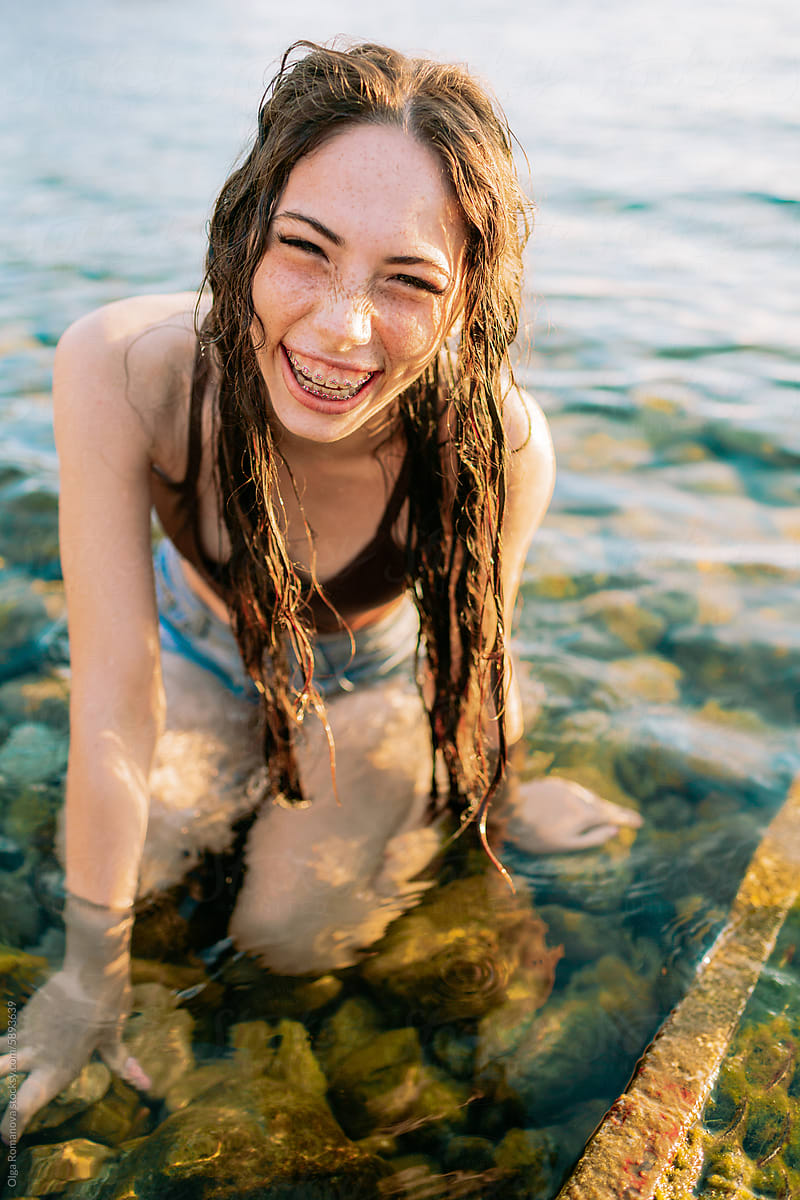 Summer sea portrait of teenage happy girl with long wet hair