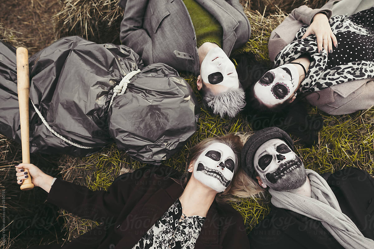 People and corpse lying on haystack