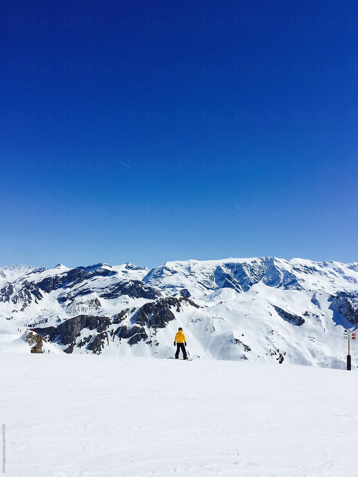 Man enjoying snowboarding vacation. Beautiful mountain range in France. Fun winter vacation of extreme sport