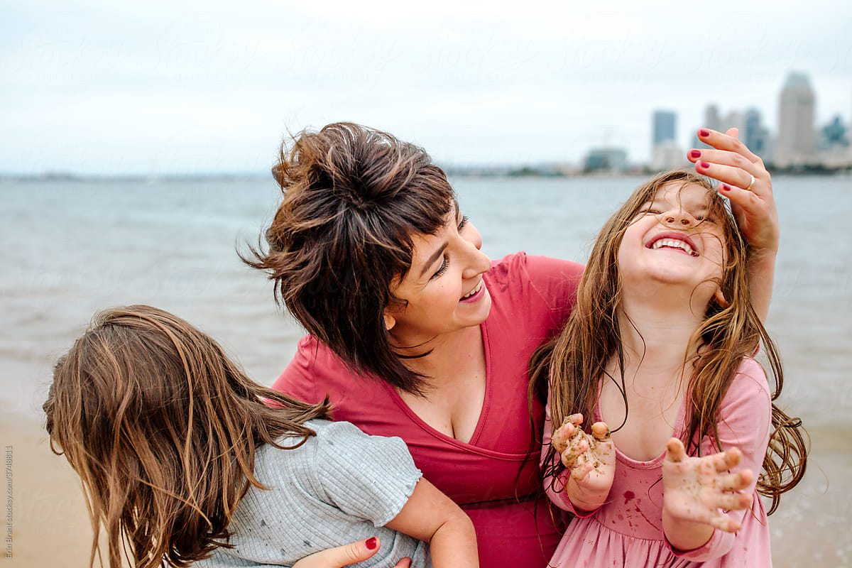Mother with happy daughters at beach