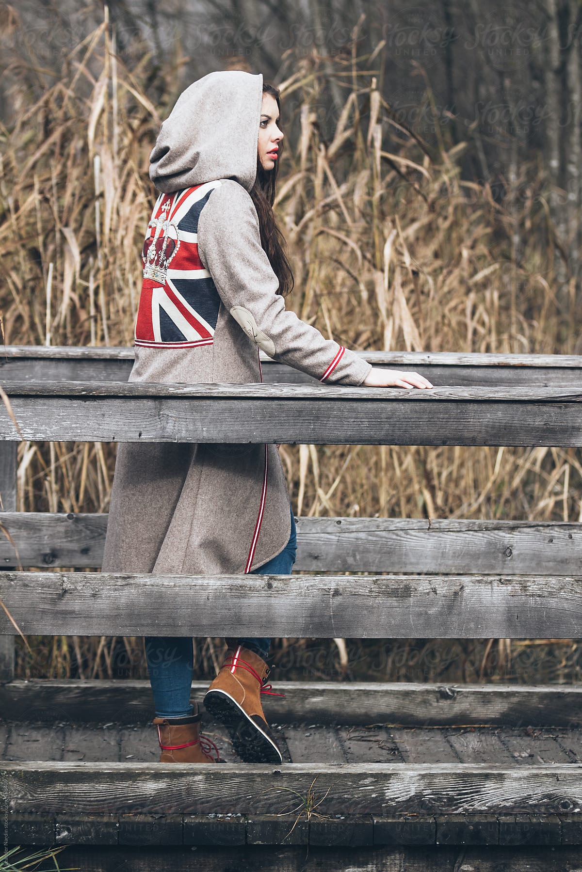 Beautiful Hooded Brunette Woman Posing On A Jetty By Stocksy Contributor Akela From Alp To