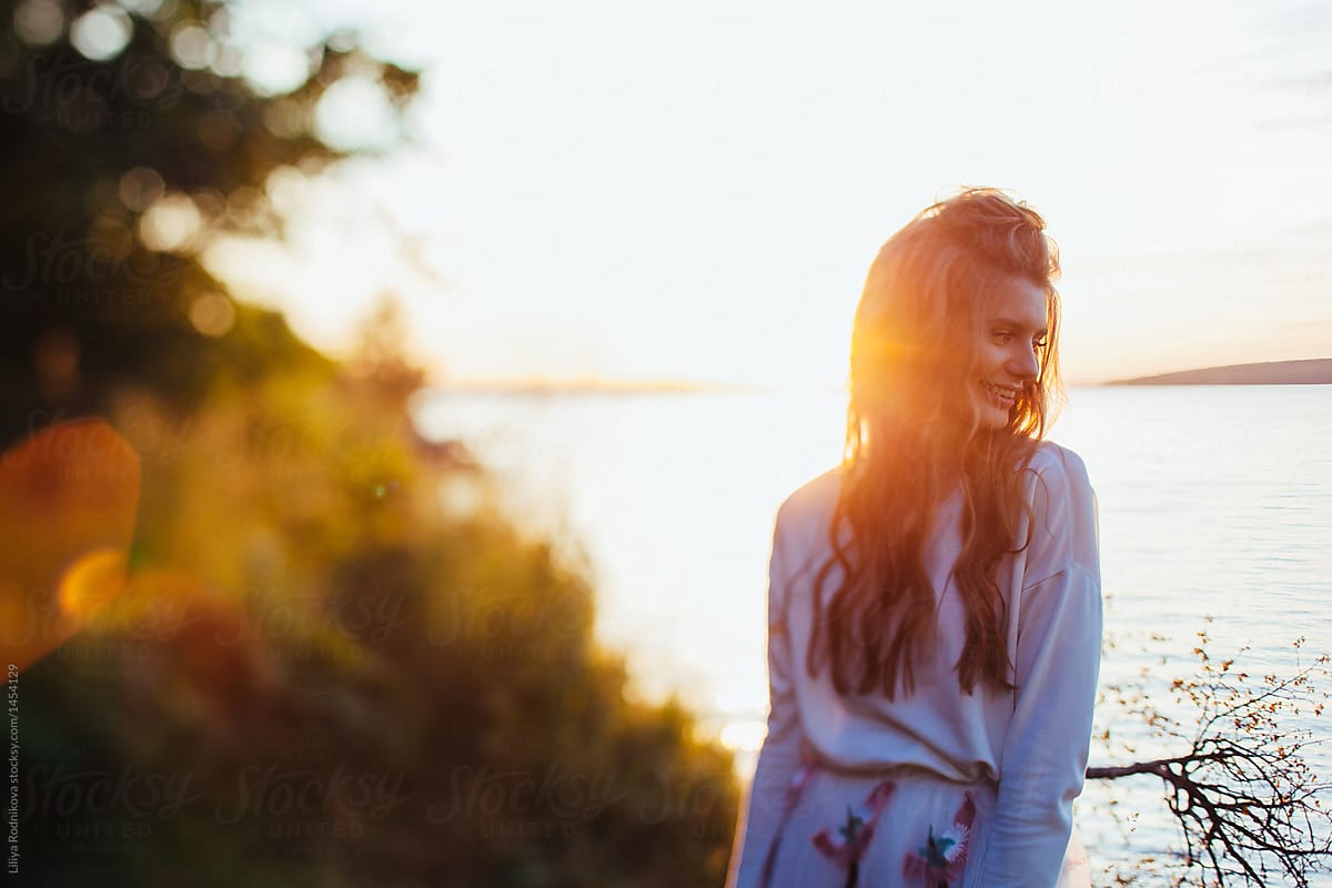 Soft focus portrait of smiling woman in sunlight