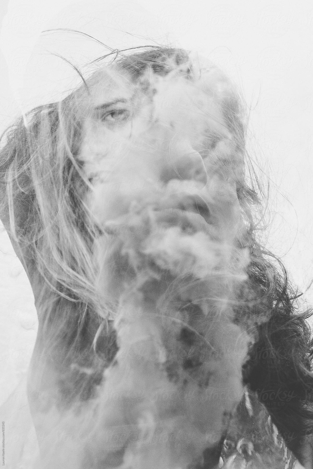 Double exposure of woman and smoke