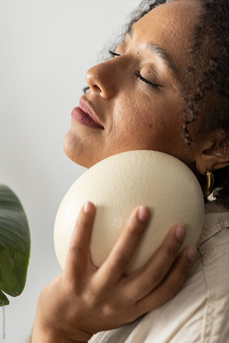 Meditating woman with Ostrich egg