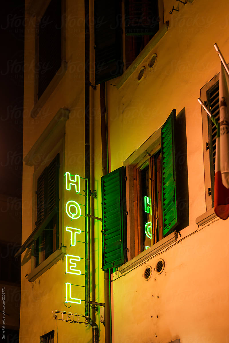 Illuminated hotel sign on the wall.