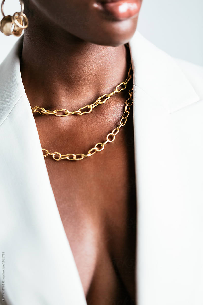 Black woman in stylish jewelry in studio