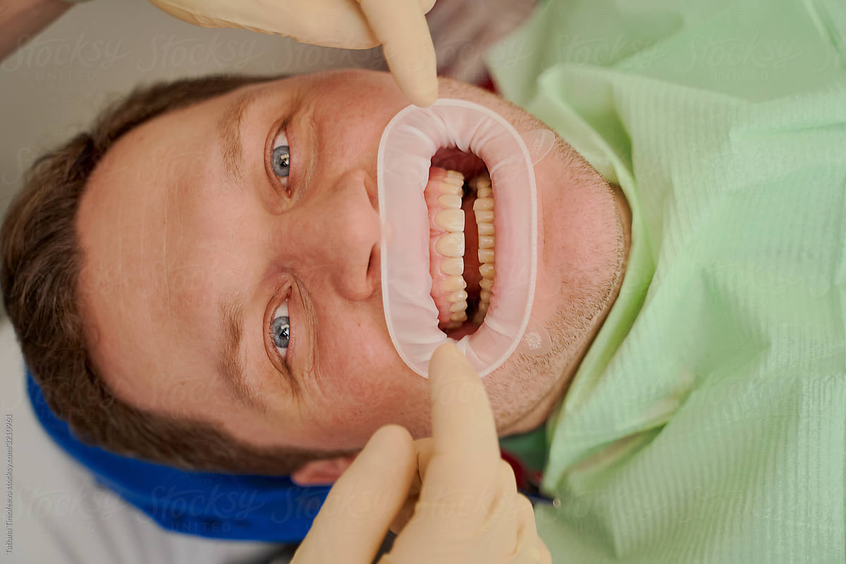 a dentist in a dental clinic tells the client how to treat and care for their teeth