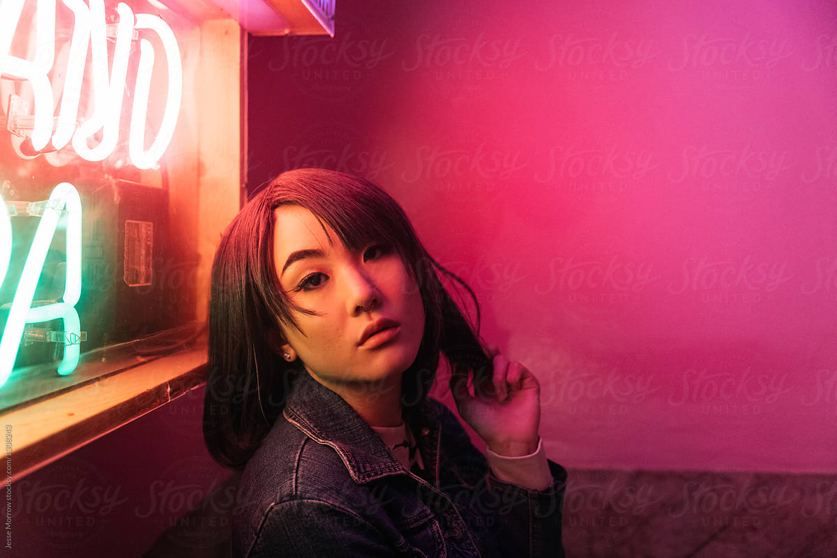 Portrait Of Young Asian Female Woman In Pink Room With Neon Lights By