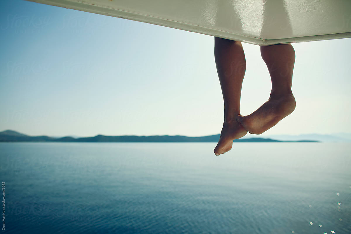 Dangling legs over the side of a boat