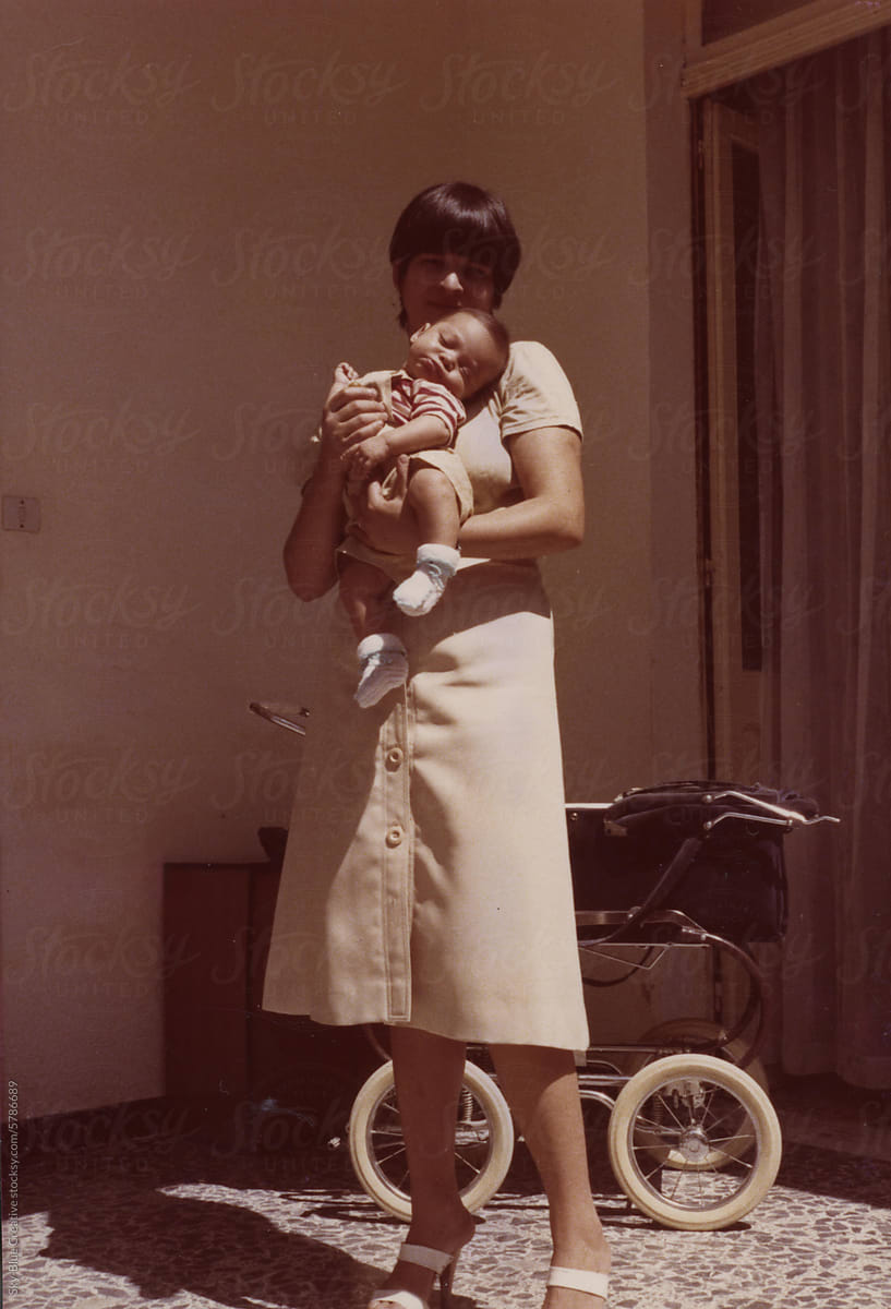 1978. Mother and newborn posing for a photo at home