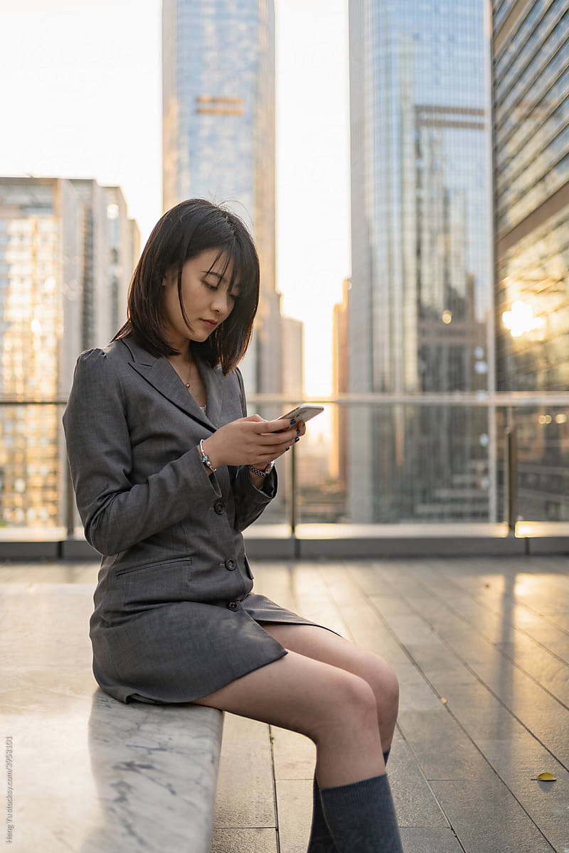 Business Woman using her phone outdoor