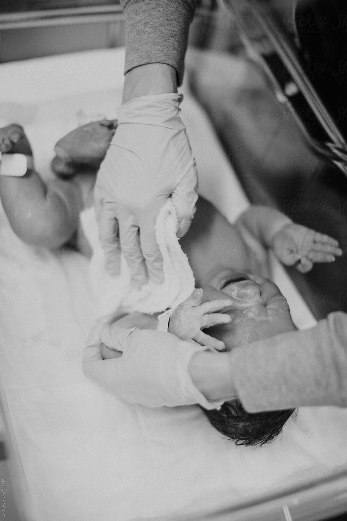 Newborn boy being washed at hospital