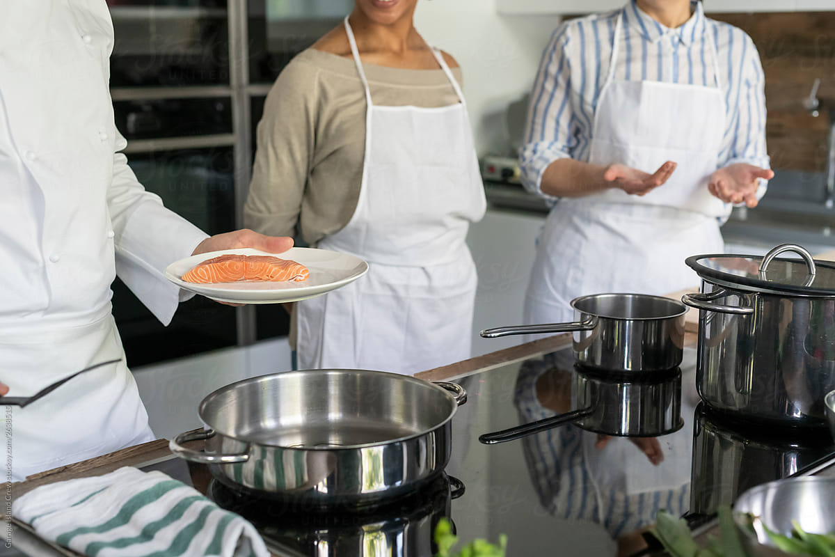 Cooking salmon during a kitchen class