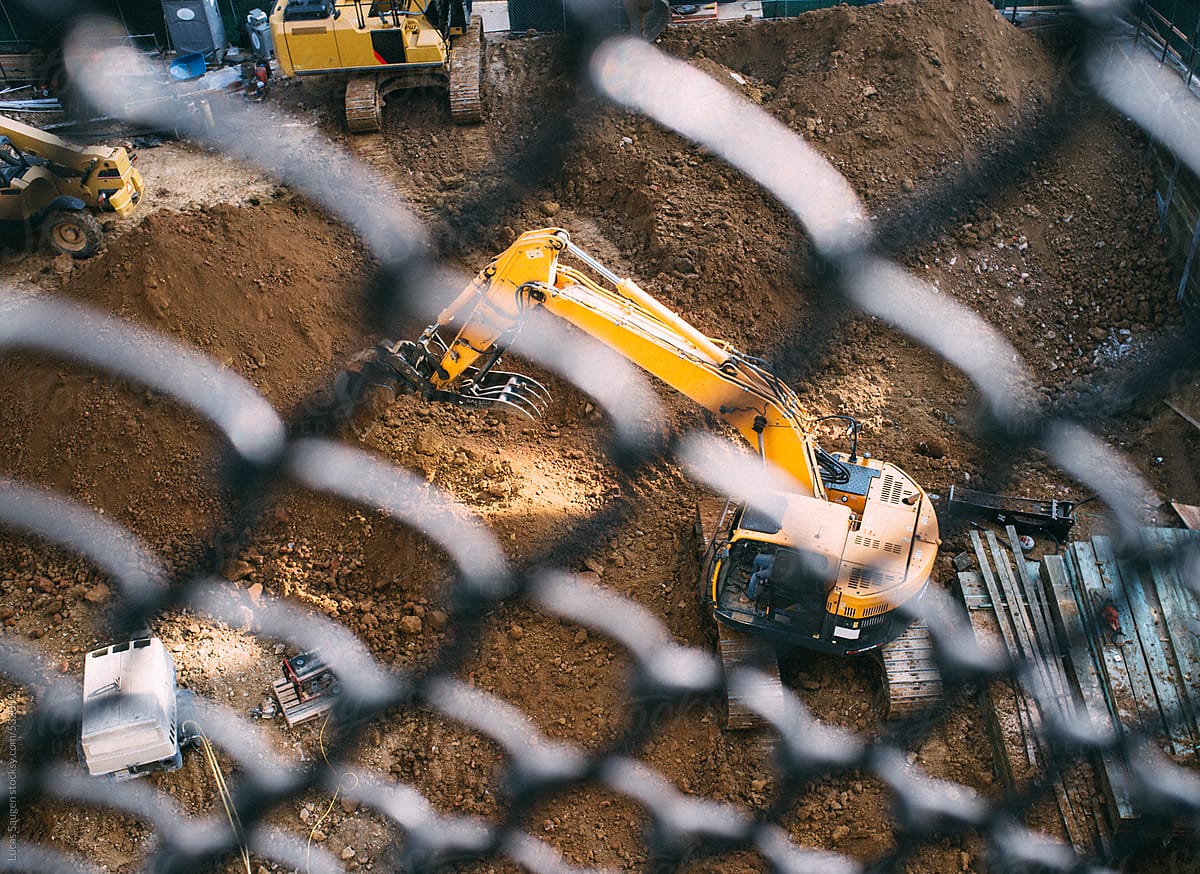 Big piece of construction equipment digging a big hole.