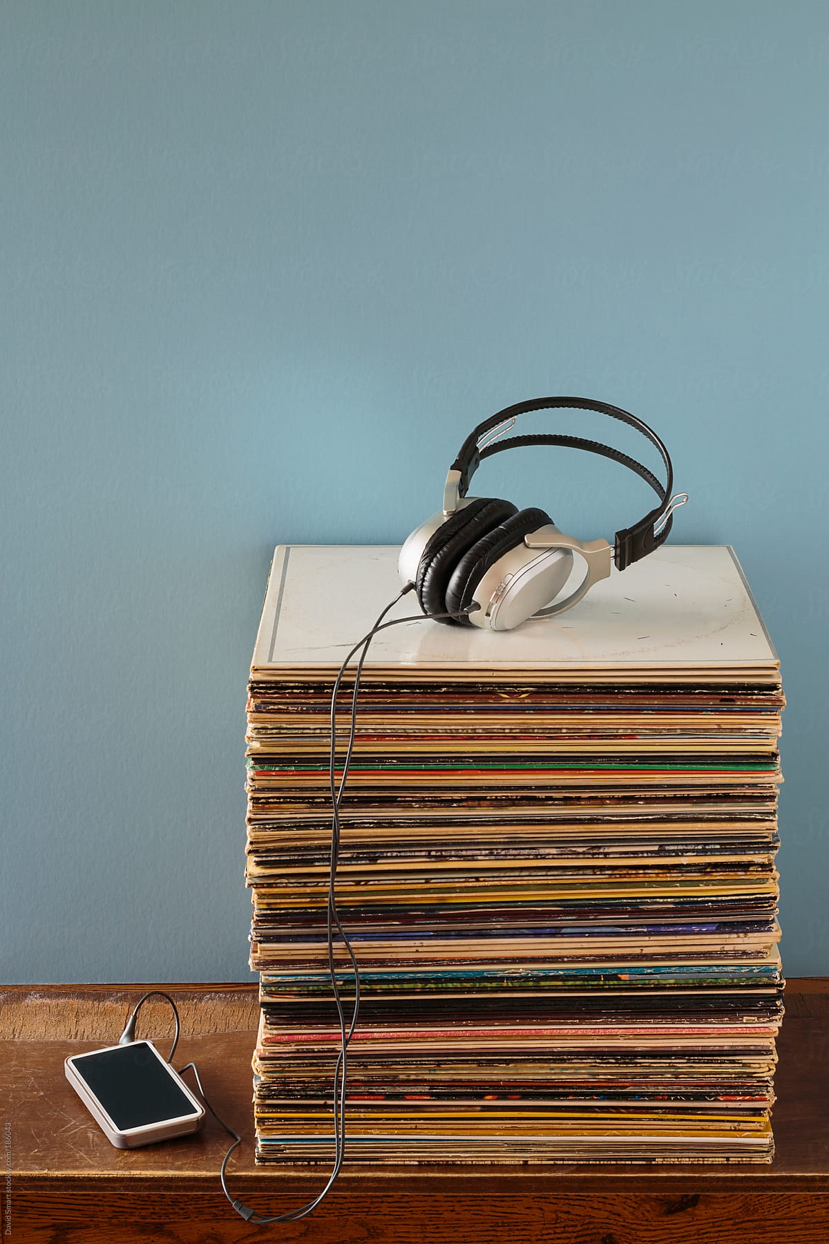 Vinyl record albums, headphones and a mobile phone