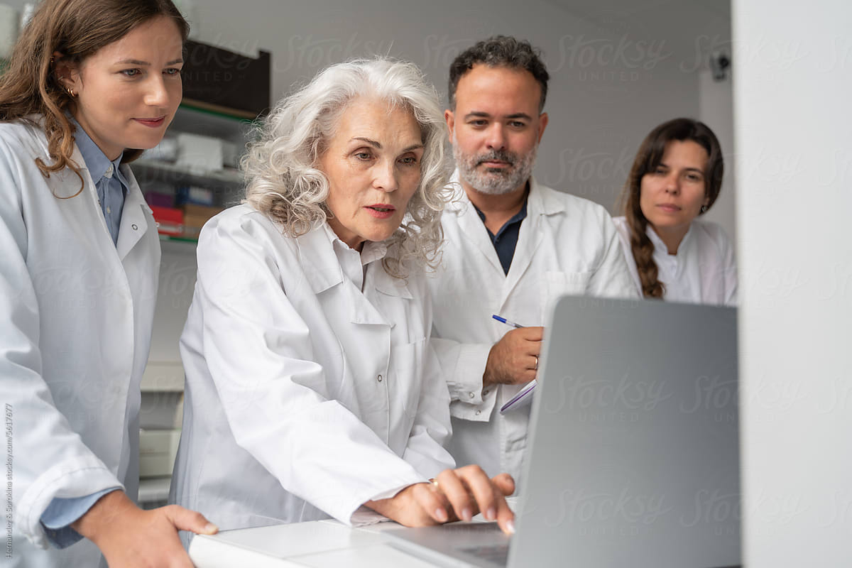 Group Of Researchers Using Computer In Lab