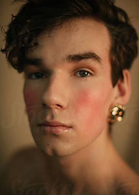 Portrait Of A Queer Guy With Curly Hair And Golden Earrings