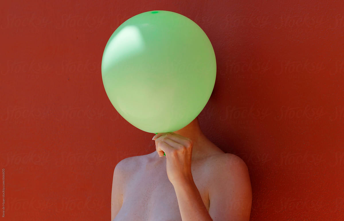 woman holding balloon in front of her